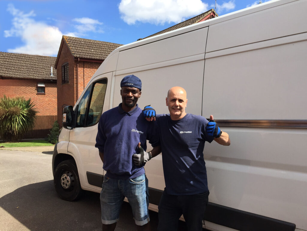 About Van Man Northampton - this image shows two of our movers in uniform next to the van, both are smiling