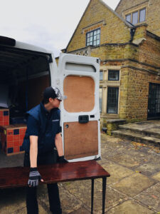 How to Prepare for Your Move with Van Man Northampton this picture shows one of our movers handling an antique table