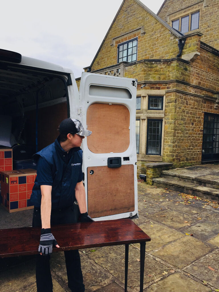 How to Prepare for Your Move with Van Man Northampton this picture shows one of our movers handling an antique table