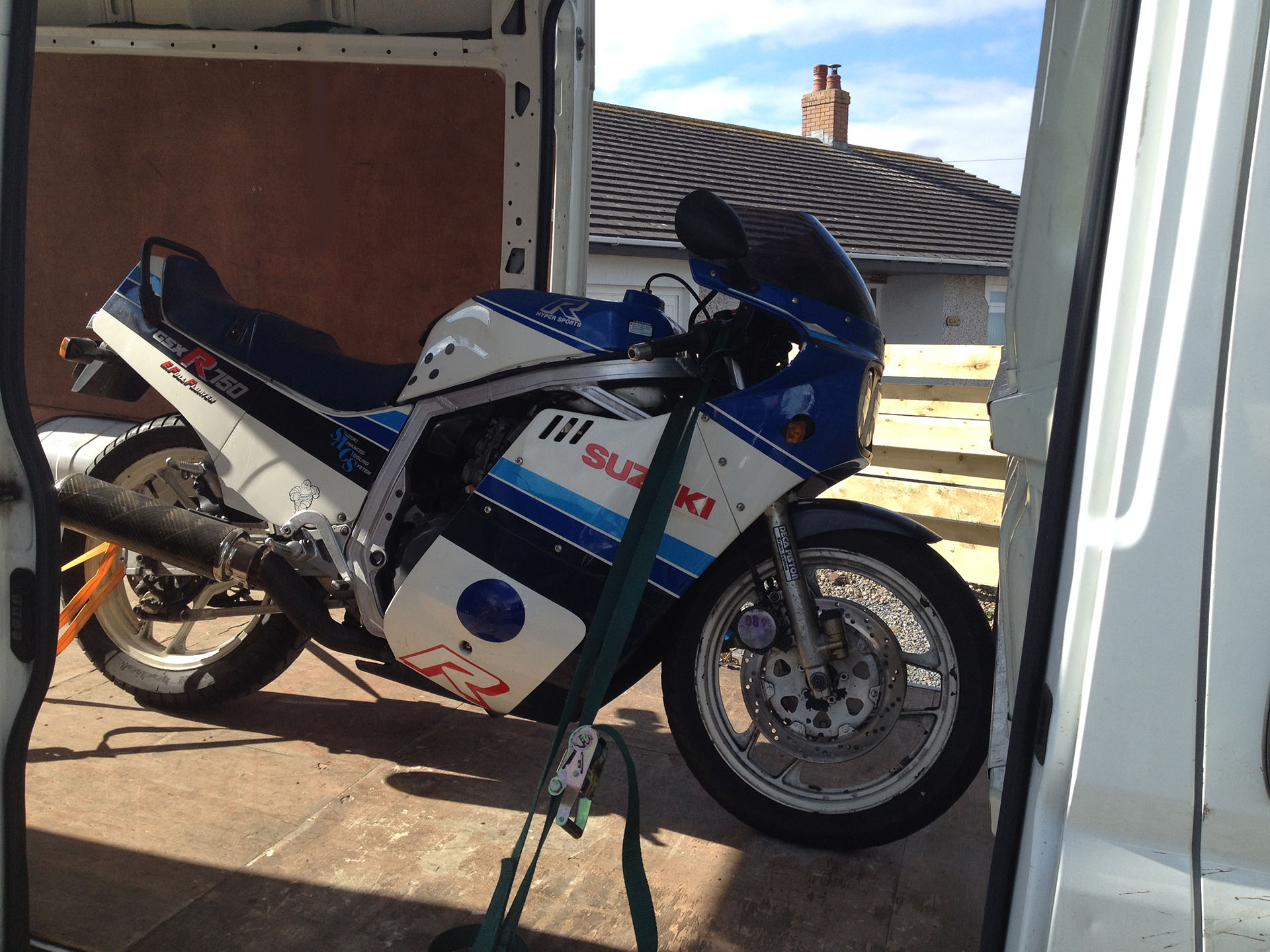 Motorcycle Transportation - this image shows a motorbike in one of our vans securely strapped in place